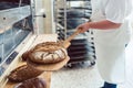 Woman in bakery putting bread on board