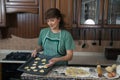 The woman bakes cookies in the kitchen