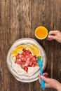 Woman bakes strawberry pie. Woman smears a pie with an egg, view from above, top view Royalty Free Stock Photo