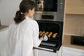 Woman baking home-made muffins in modern domestic kitchen Royalty Free Stock Photo