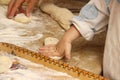 Woman baking pies in kitchen with little one-two granddaughter. Grandma cooks pies and learn child. making pie by hand. Transfer o
