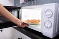 Woman Baking Pizza In Microwave Oven