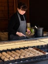 Woman Baking Trdelnik Spit Cakes on a Charcoal Fire