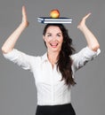 Woman balancing apple and books on head Royalty Free Stock Photo