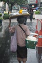 Woman balancing groceries on her head