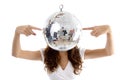 Woman balancing mirror ball with fingers