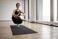 Woman balancing on one leg and keeping hands in namaste Royalty Free Stock Photo