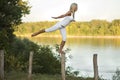 Woman balancing beside river