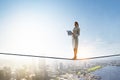 Woman on balancing rope with a book