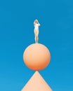 Woman balancing sphere cone balance blue sky warm summer sunlight