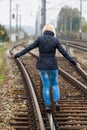 Woman balancing on track. decisions