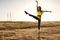 Woman in Balet Pose in a Field