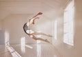 Woman ballet dancer dancing in a dance studio mockup white walls and sunlight. Young professional girl, art or sports Royalty Free Stock Photo