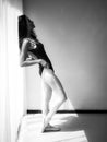 Woman ballet dancer standing post against the window, Beautiful pose