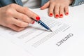 Woman with ballpoint pen signing contract document Royalty Free Stock Photo