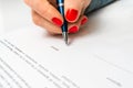 Woman with ballpoint pen signing contract document Royalty Free Stock Photo