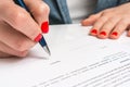 Woman with ballpoint pen signing contract document Royalty Free Stock Photo