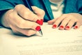 Woman with ballpoint pen signing contract document Royalty Free Stock Photo