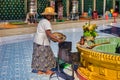 Woman bamboo hat and clay mask prepared gift tray at Yangon temple Royalty Free Stock Photo