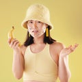 Woman, banana phone call and studio portrait, question or eyes sticker art on confused face. Asian model girl, yellow