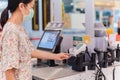 Woman with bank card paying food at grocery store self-checkout. Royalty Free Stock Photo