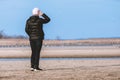 Woman on the bank of a shallow river looks into the distance