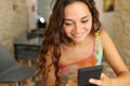 Woman in a bar using phone alone Royalty Free Stock Photo