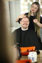 Woman Barber Making Haircut for Smiling Man Client