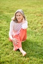 Woman with bare feet sitting on lawn