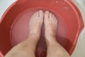 Woman bare feet in soap water at home