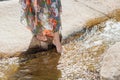 Woman with bare feet standing next to the running river Royalty Free Stock Photo