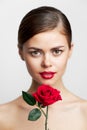 Woman with bare shoulders With a flower in her hands, a charm model red lips Royalty Free Stock Photo