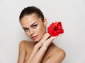 woman with bare shoulders red flower in hands charm Royalty Free Stock Photo