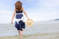 Woman barefoot walking on summer along wave of sea water and sand on the beach Royalty Free Stock Photo