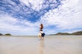 Woman barefoot walking on summer along wave of sea water and sand on the beach Royalty Free Stock Photo