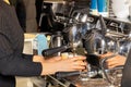 The woman barista prepares coffee in a coffee machine and pours it into paper cups Royalty Free Stock Photo