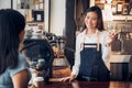 Woman barista talking with customer about tasted of coffee cup with happy emotion at counter bar at cafe.coffee shop business owne Royalty Free Stock Photo