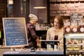 Woman bartender at cafe or coffee shop cashbox Royalty Free Stock Photo