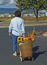 Woman with basket cart with flowers