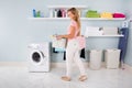 Woman With Basket Of Clothes In Utility Room