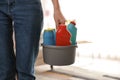Woman with basket of professional cleaning products, closeup. Space for text Royalty Free Stock Photo