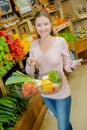 Woman with basketful fruits and list