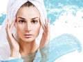 Woman with bath towel on head in water splashes.