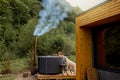 Woman bathing in hot tube, while resting with her dog on nature Royalty Free Stock Photo