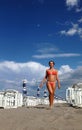 Woman in bathing suit goes on sand on beach