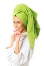 Woman in bathrobe brushing teeth Royalty Free Stock Photo