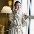 Woman in bathrobe on phone.