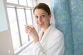 Woman in a bathrobe relaxing and drinking tea Royalty Free Stock Photo