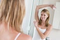 Woman in bathroom applying deodorant Royalty Free Stock Photo