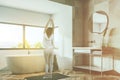 White bathroom corner, tub and sink, woman Royalty Free Stock Photo